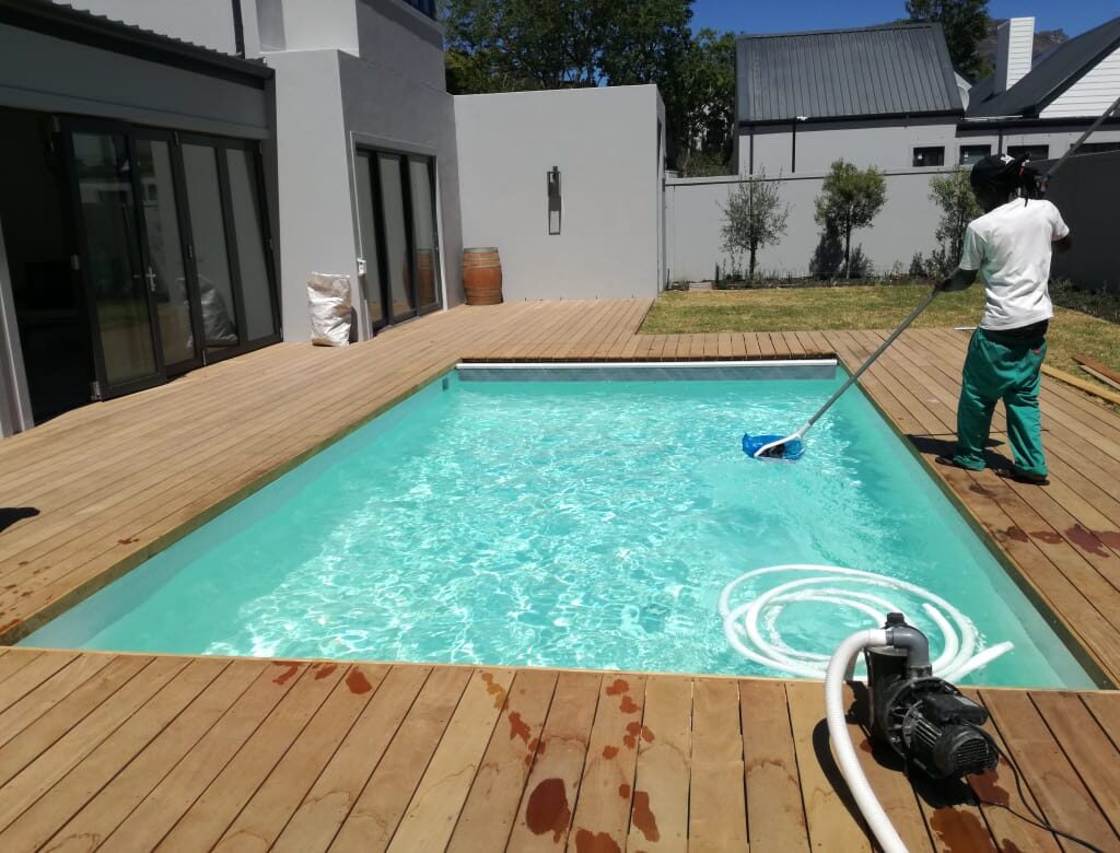 Swimming pool cleaning service on fiberglass pool using a pool pump and pool cleaning equipment, Higgovale, City Bowl, Cape Town.